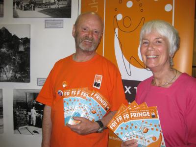 Fringe chair Keith Savage with The Green Man’s Suzanne Pearson against a backdrop of their new photographic exhibition, The Quarrymen.