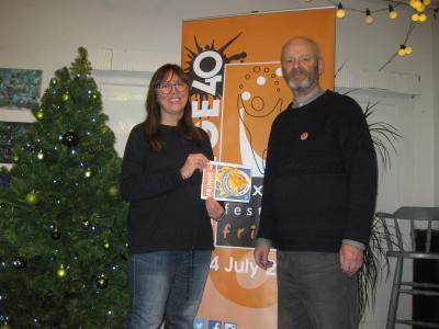 Catherine Webb with her winning artwork for the Fringe 2019 cover alongside Fringe chair Keith Savage posing at the Green Man Gallery